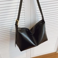 Minimalist black faux leather tote bag with glossy finish and gold metal buckle detail - Black