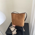 Brown suede bucket bag with dark leather trim and minimalist crossbody strap design - Tan