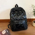 Glossy black quilted backpack featuring a minimalist padded design and large front pocket - Black
