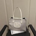 White tote bag with grey M-letter monogram print and large leather logo on the front - White
