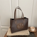 Deep brown tote bag with vintage monogram pattern and textured leather handles - Brown