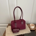 Retro burgundy suede shoulder bag with matching coin pouch on a cozy wooden table - Burgundy