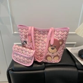 Pink geometric large tote bag with bear print and matching small pouch on leather bench - Pink