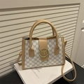 Retro shoulder bag with white M-monogram pattern and golden metal buckle closure - White