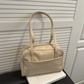 Minimalist beige matte leather underarm tote bag with silver zipper on books - Khaki
