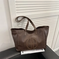 Deep brown oversized vintage tote bag with circular embossed logo and twin top handles - Brown