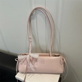 Pink faux leather baguette bag featuring a white lace bow and drawstring side details - Pink