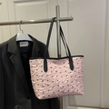 Pink pleated tote bag with black bow prints and long shoulder straps for daily commute - Pink