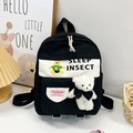 Zaino per bambini in tela bianco e nero con stampa di orso e ciondolo in peluche - Nero