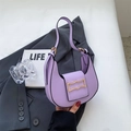 Detail of lavender crescent shoulder bag with gold buckle on grey blazer with LIFE magazine - Purple