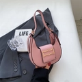 Detail of pink half-moon shoulder bag featuring a unique wavy gold metal buckle closure - Pink