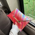 Pink holographic envelope clutch bag with metallic trim in a stylish fashion setting - Rose Red
