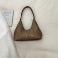 Detailed view of the brown pleated leather texture and silver zipper on this crescent bag - Brown