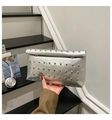 Close-up of silver metallic clutch bag with four rows of silver rivet studs on the flap - Silver