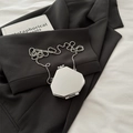 Mini octagonal silver mirror crossbody bag with metal ball chain on a black suit - Hexagon Box Silver