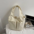 Minimalist beige multi-pocket tote bag with laptop and headphones in office setting - Off-white