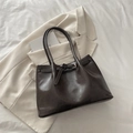 Deep brown faux leather tote bag with buckle detail on a white blazer background - Coffee without Pendant