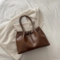 Brown leather tote bag in large size with belt buckle detail on a beige blazer background - Brown No Pendant