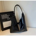 Detail of black pebbled leather tote bag with matching small zippered accessory pouch - Black