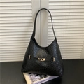 Minimalist black woven tote bag with gold buckle on Kinfolk magazine background - Classic Black