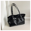 Detail of black glossy tote bag with silver metal buckles and eyelet decorations - Black