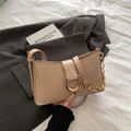 Beige faux leather baguette handbag with a gold horseshoe clasp and chain detail - Khaki