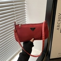Minimalist red nylon underarm bag with a metal triangle logo and zipper closure - Red
