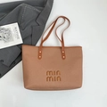 Caramel woven texture tote bag with logo and gold rivet accents on long handles - Brown