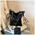 Detail of glossy black bucket bag with silver chain and cute teddy bear charm - Black With Pendant