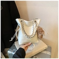 Close-up of white leather bucket bag with silver chain strap and cute bear charm pendant - White With Pendant