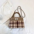Detail of tweed and brown leather patchwork texture on a vintage crossbody bag - Khaki