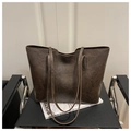 Detail of vintage brown tote bag texture on leather chair with magazine prop - Coffee