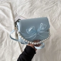 Light blue faux leather handbag with tulle bow and elegant pearl chain handle - Blue