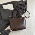 Minimalist dark brown glossy underarm bag with silver ring detail and knotted shoulder strap - Brown