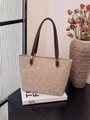 Detailed close-up of marble pattern tote bag with gold hardware and slim brown handles - Off White