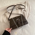 Dark brown flap crossbody bag with 'M' monogram print and silver metal chain detail - Brown
