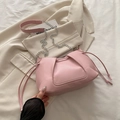 Pink pleated tote bag with silver chain and side drawstrings on beige blazer jacket - Pink
