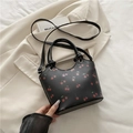 Black leather tote bag with red cherry print featuring knotted handles and crossbody strap - Black