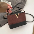 Brown frosted suede bucket bag with black leather trim and golden V hardware detail - Brown