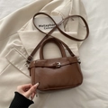 Vintage brown leather crossbody handbag with shiny finish and decorative belt detail - Brown