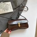 Retro dark brown PU leather underarm bag with gold lock on grey blazer background - Brown