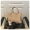 Detail of ribbed beige tote bag featuring sleek handles and a slim shoulder strap - Khaki