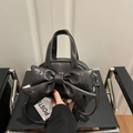 Dark gray faux leather handbag featuring a large bow and silver star rivets - Gray
