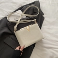 Chic cream white bucket bag with pebble leather texture and golden V-shaped metal buckle - White