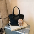 Minimalist black matte underarm bag with a brown plush dog charm and top handles - With Pendant / Black