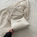 Creamy white hobo bag with a golden bow detail and elegant pebble grain texture - White