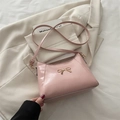 Pink crescent shoulder bag with metallic bow buckle and adjustable leather strap - Pink