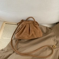 Brown frosted leather cloud bag with pleated details on a beige trench coat - Brown