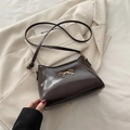 Chocolate brown patent leather shoulder bag with a gold bow accent and strap - Brown
