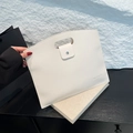 Minimalist white lychee leather handbag with oval cutout handle and envelope closure - White